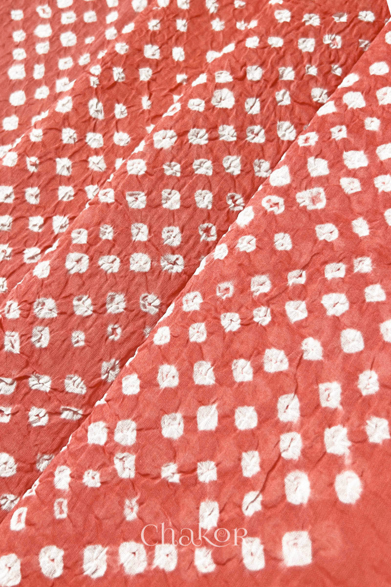 Close-up of Dark Peach Bandhani tie-dye dot pattern on mul cotton dupatta.
