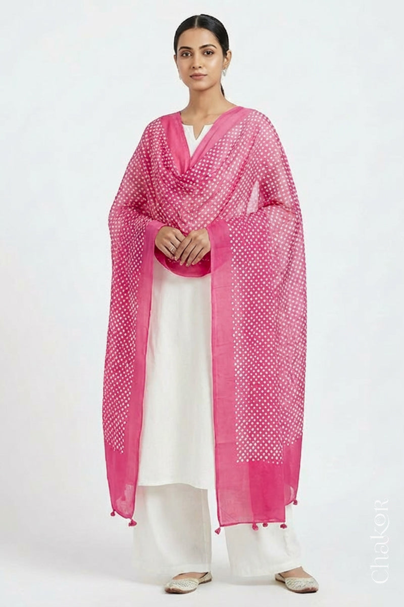 Model wearing Pink Bandhani mul cotton dupatta with tie-dye dot pattern draped over a white kurta.