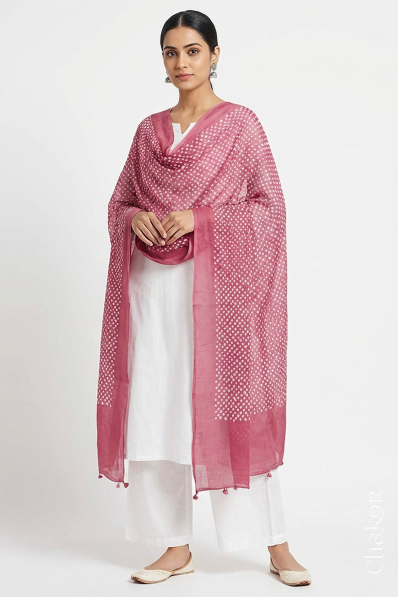 Model wearing Old rose Bandhani mul cotton dupatta with tie-dye dot pattern draped over a white kurta.