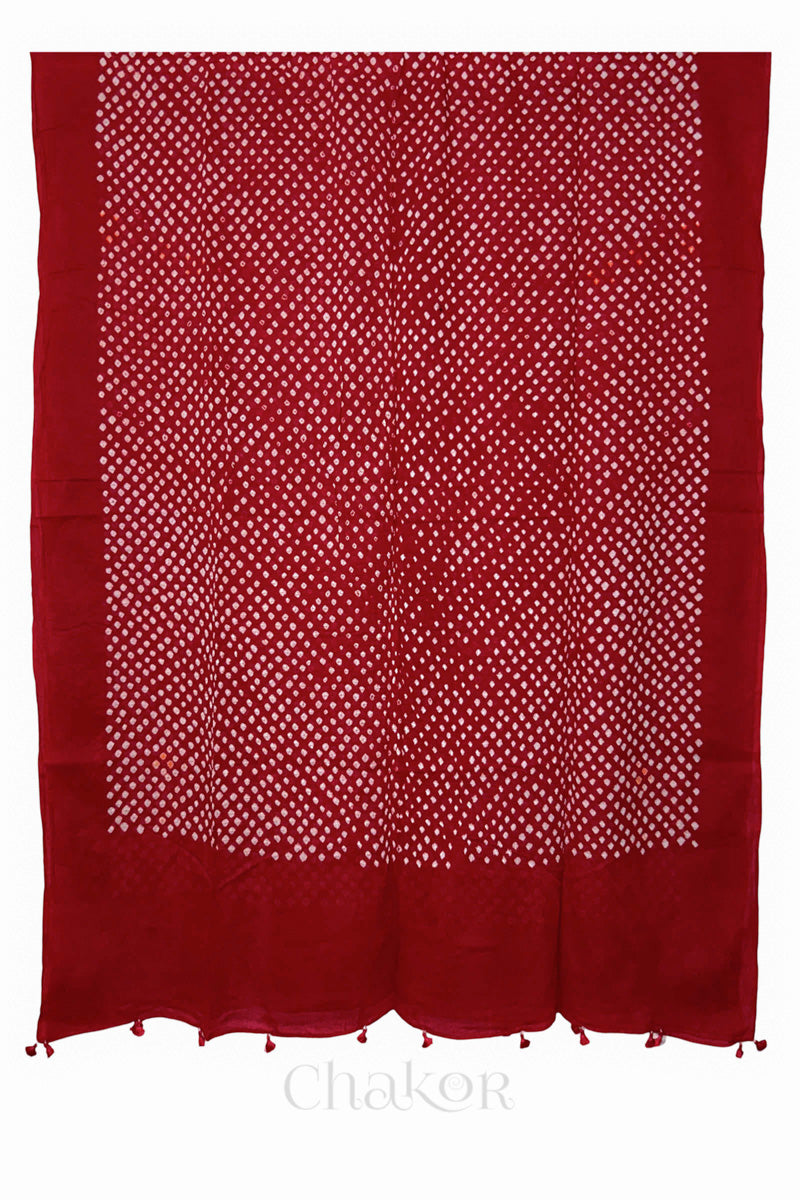 Chakor's red cotton mul mul dupatta with white bandhani pattern, edged with tassels at the edge.