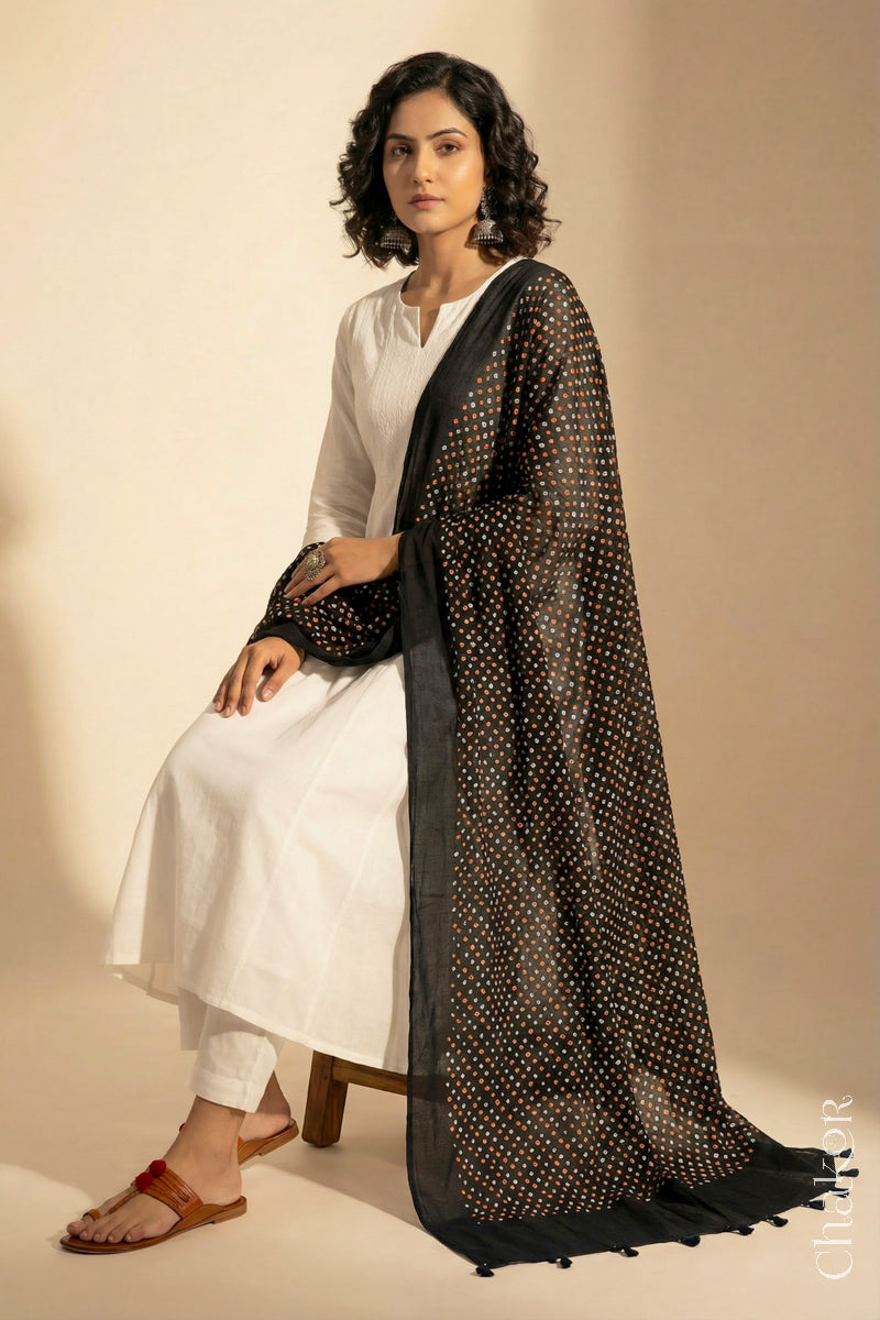 Black Mercerised Mulmul Bandhani Dupatta detailed with tassels draped on model - CHAKOR