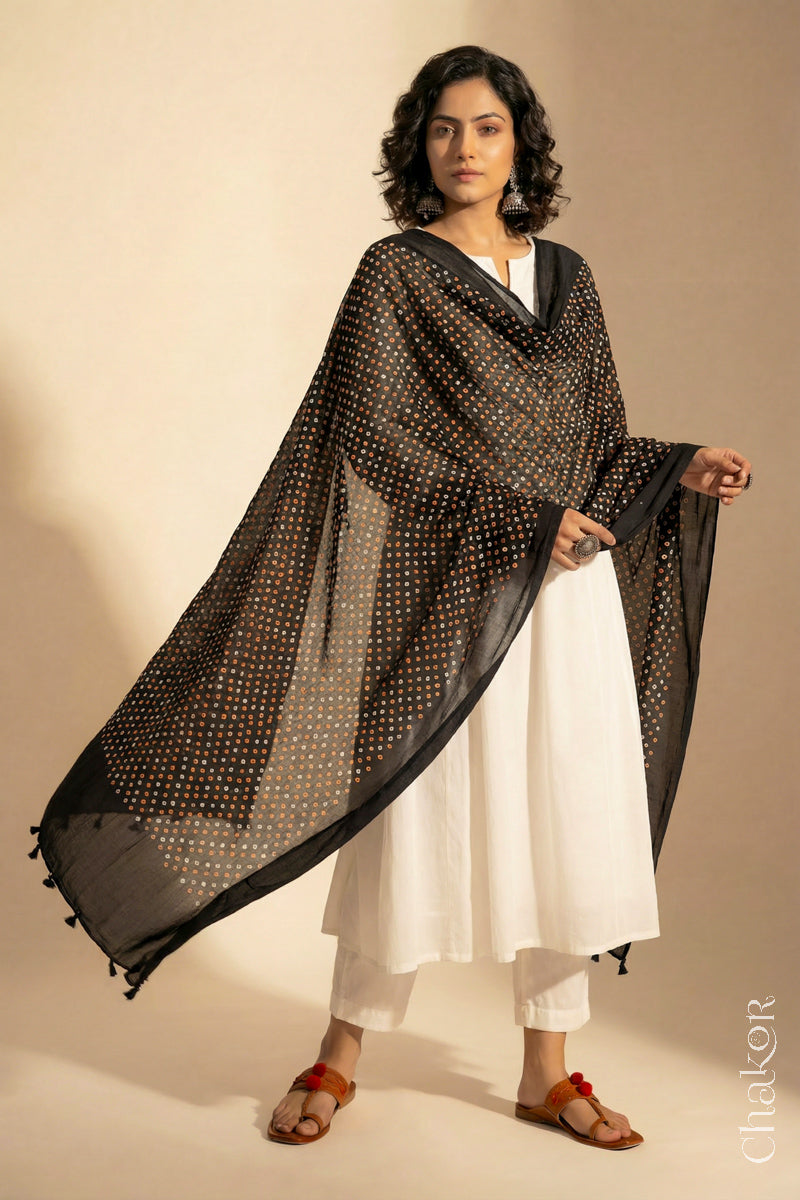 Black Mercerised Mulmul Bandhani Dupatta detailed with tassels draped on model - CHAKOR