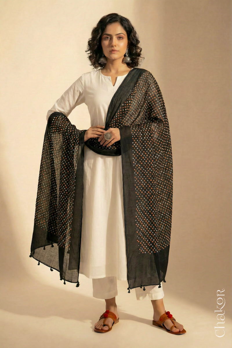 Black Mercerised Mulmul Bandhani Dupatta detailed with tassels draped on model - CHAKOR