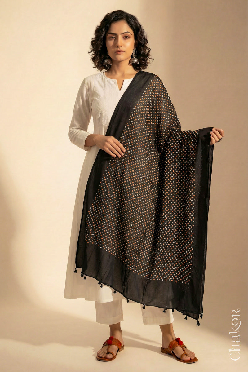 Black Mercerised Mulmul Bandhani Dupatta detailed with tassels draped on model - CHAKOR