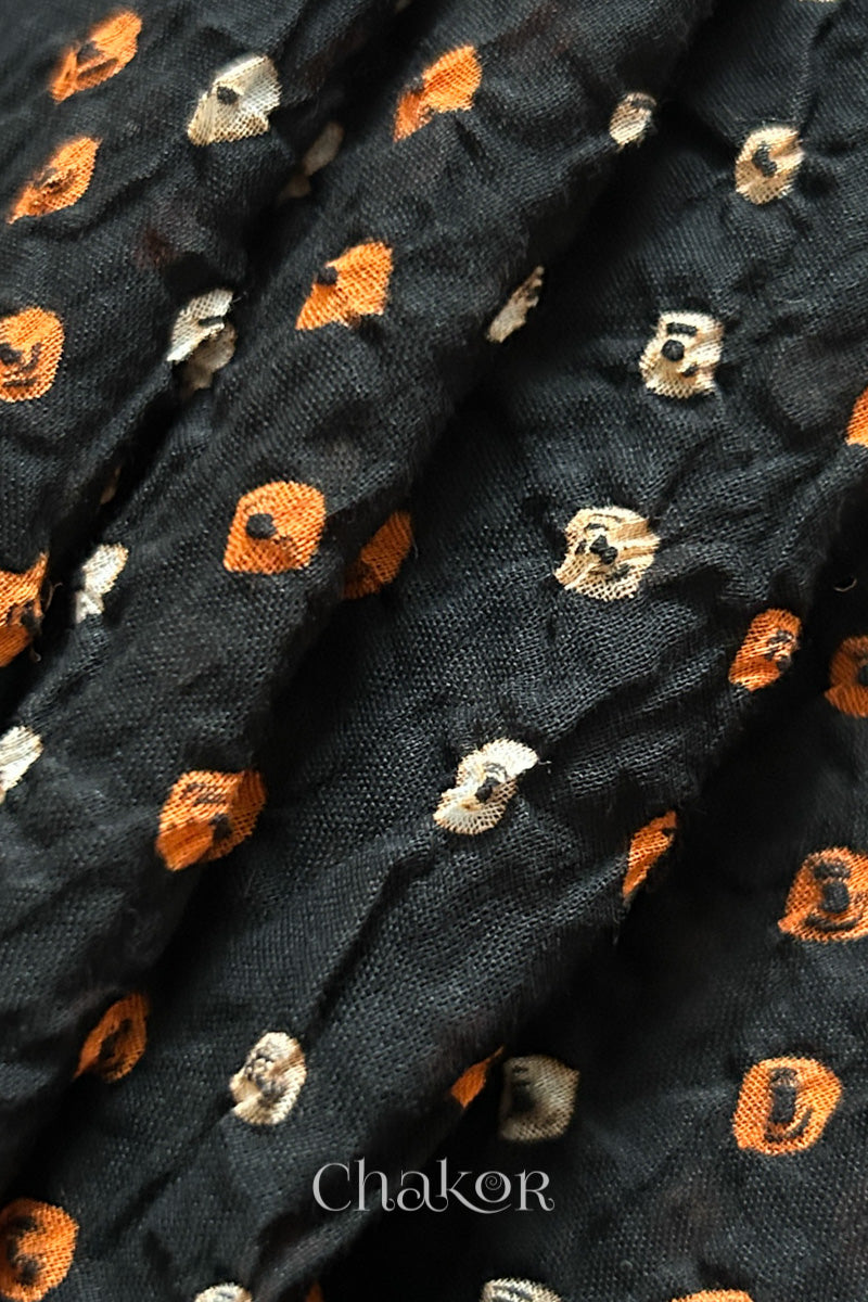 Close up of Handcrafted Black Tie-dye Bandhani dupatta featuring dense white and orange tie-dye dot pattern by CHAKOR.