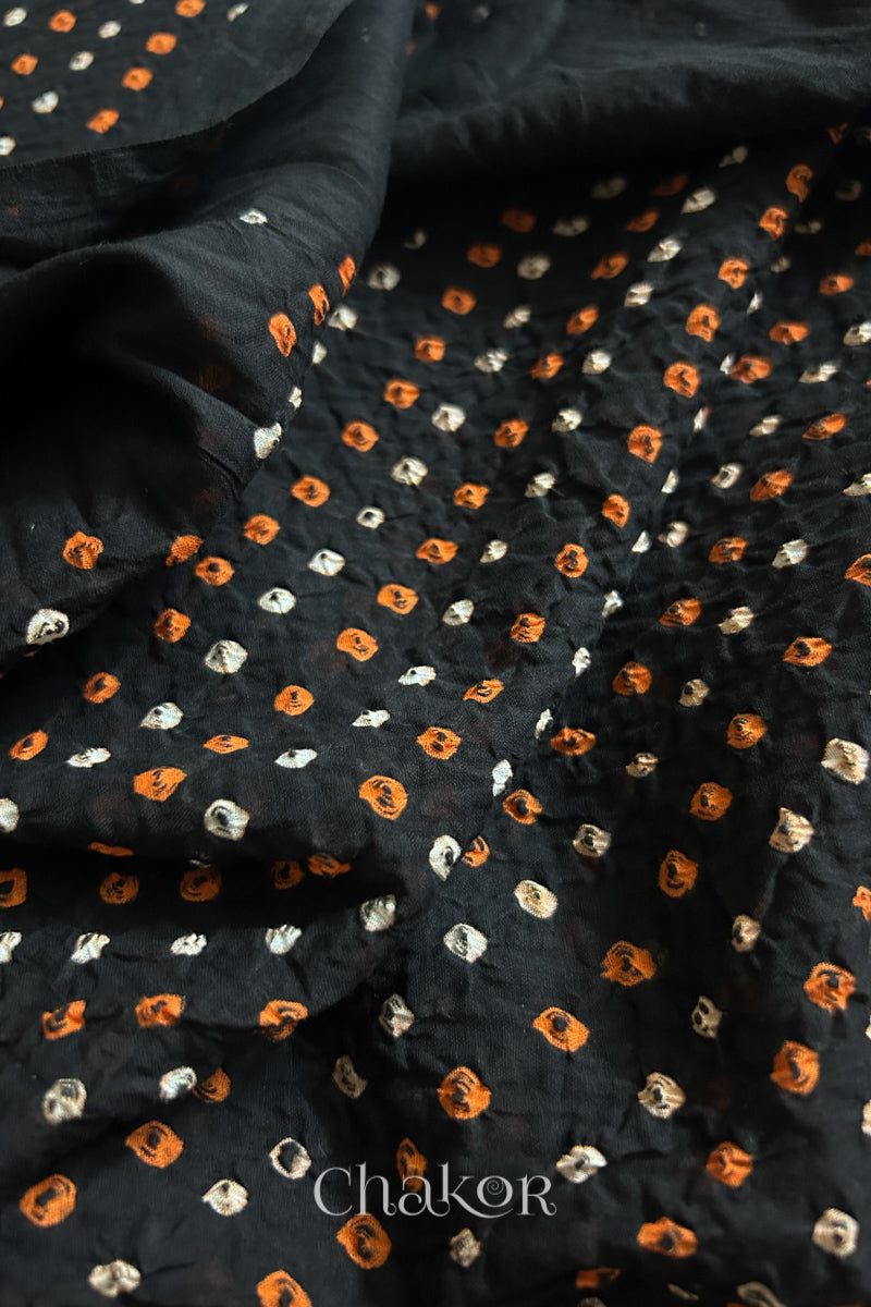 Close up of Handcrafted Black Tie-dye Bandhani dupatta featuring dense white and orange tie-dye dot pattern by CHAKOR.