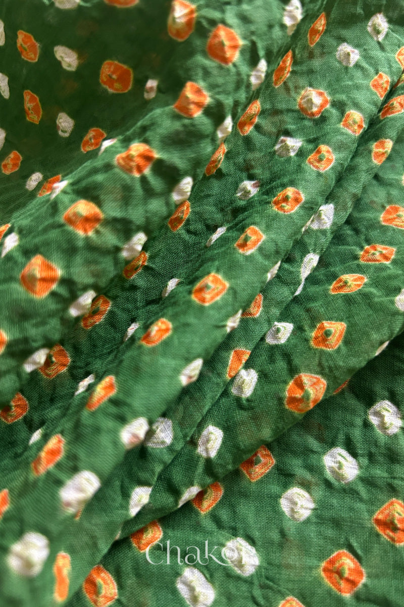 Close up of Handcrafted Mehendi Green Bandhani dupatta featuring dense white and orange tie-dye dot pattern by CHAKOR.
