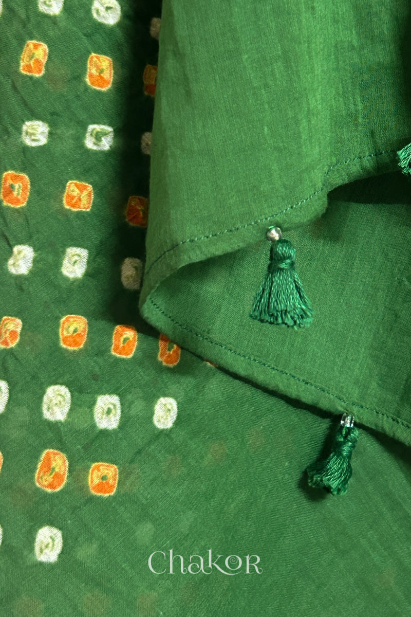Close up of Authentic Mehendi Green Bandhani dupatta featuring handmade tassels and dense white & orange tie-dye dot pattern by CHAKOR.