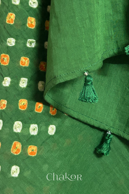 Close up of Authentic Mehendi Green Bandhani dupatta featuring handmade tassels and dense white & orange tie-dye dot pattern by CHAKOR.