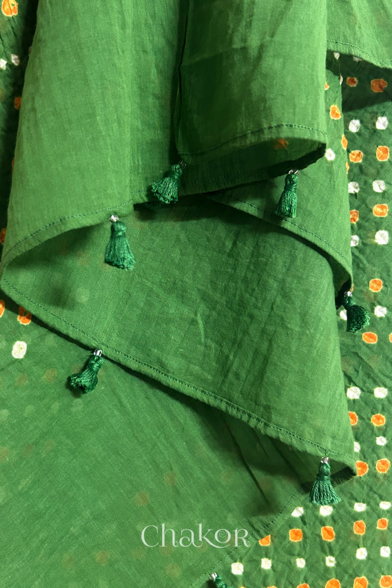 Close up of Authentic Mehendi Green Bandhani dupatta featuring handmade tassels and dense white & orange tie-dye dot pattern by CHAKOR.