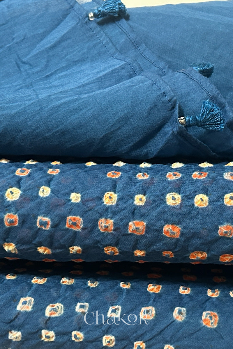 Close up of Handcrafted Indigo Blue Bandhani dupatta featuring hand made tassels & dense white and orange tie-dye dot pattern by CHAKOR.
