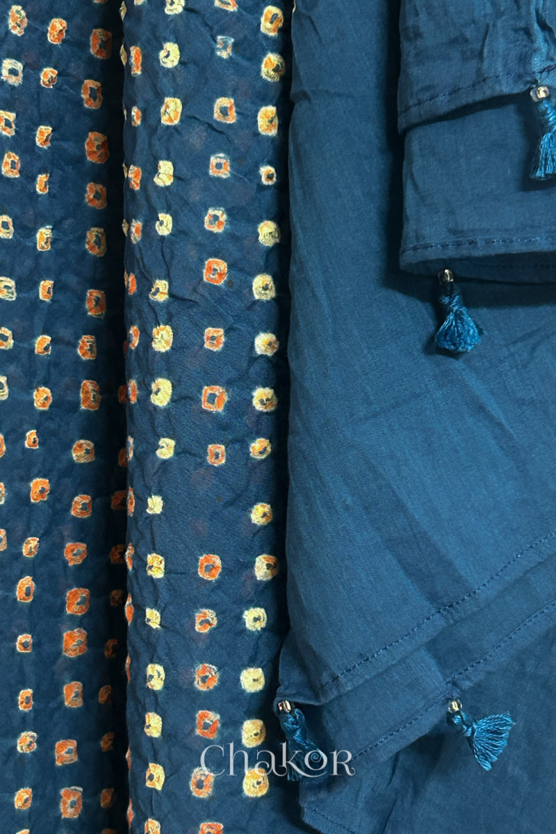 Close up of Handcrafted Indigo Blue Bandhani dupatta featuring hand made tassels & dense white and orange tie-dye dot pattern by CHAKOR.