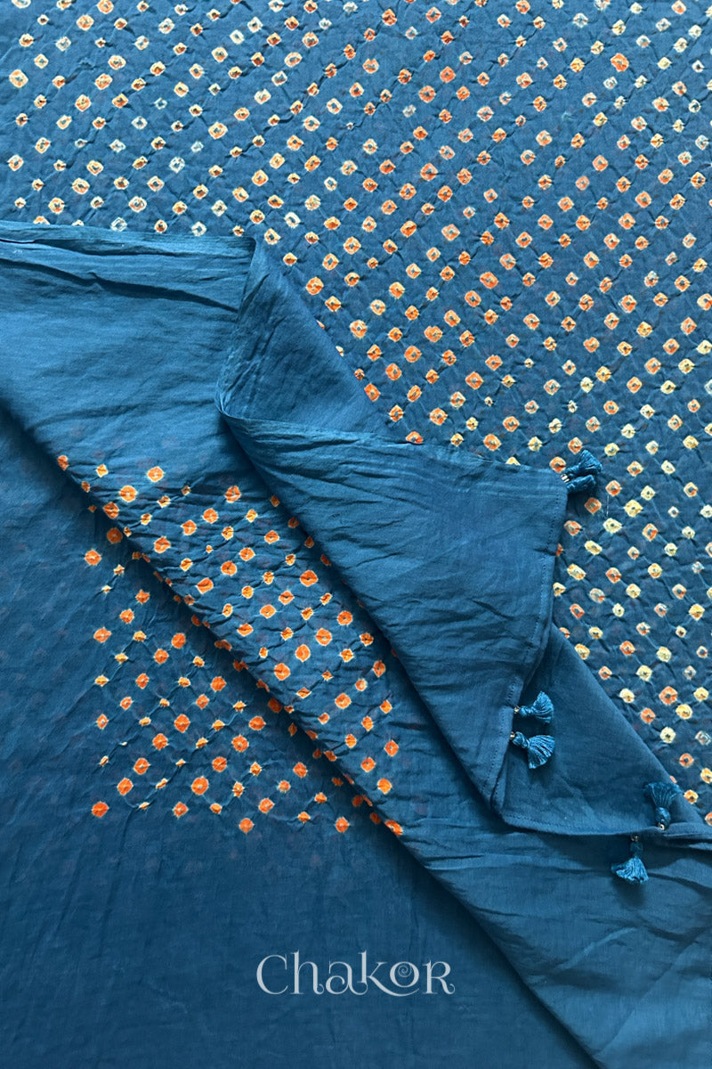 Close up of Handcrafted Indigo Blue Bandhani dupatta featuring hand made tassels & dense white and orange tie-dye dot pattern by CHAKOR.