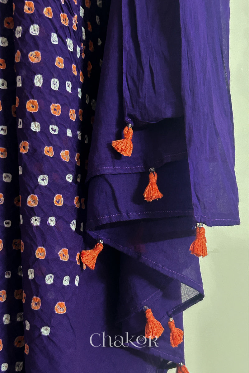 Close up of Authentic Purple Bandhani dupatta featuring handmade tassels and dense white & orange tie-dye dot pattern by CHAKOR.