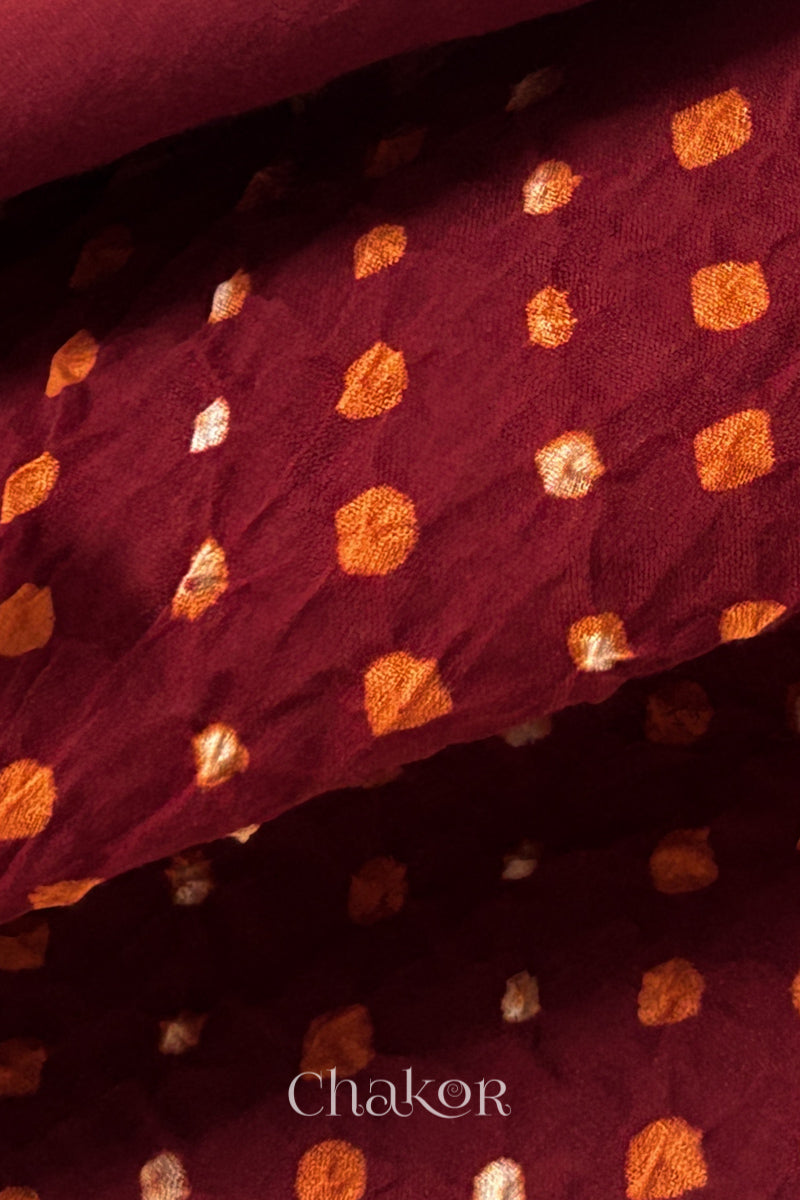 Close up of Handcrafted Red Bandhani dupatta featuring dense white and orange tie-dye dot pattern by CHAKOR.