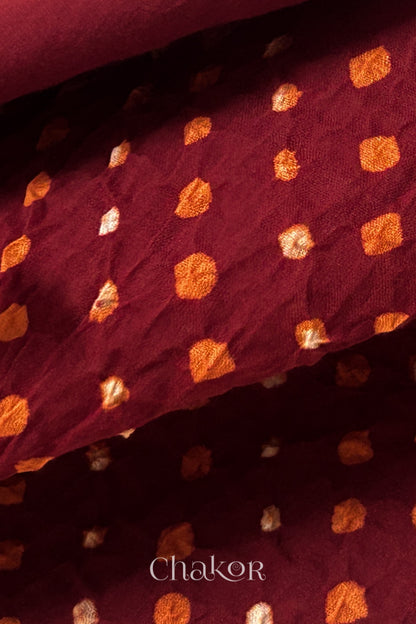 Close up of Handcrafted Red Bandhani dupatta featuring dense white and orange tie-dye dot pattern by CHAKOR.