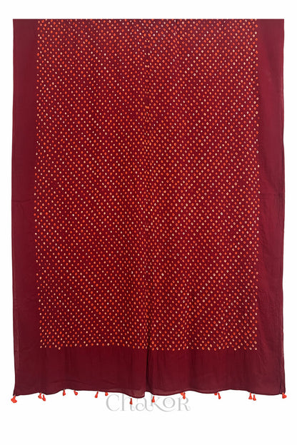 Full length view of intricate white and orange Bandhani dot pattern on Red Mulmul cotton scarf dupatta by CHAKOR.