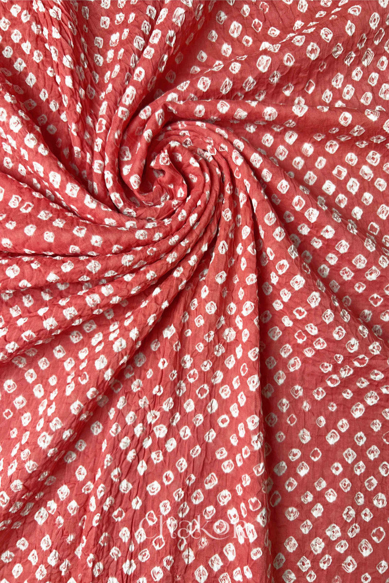 Detail view of Dusty Red Bandhani mul cotton dupatta highlighting tie-dye dots arranged in spiral drape.
