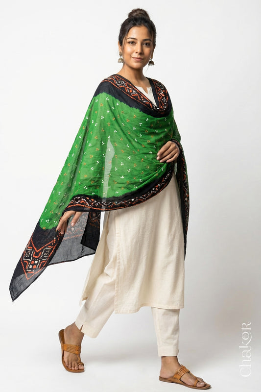 Model wearing Mehendi Green Bandhani Mul Cotton Dupatta in Traditional Design over a white kurta set.  