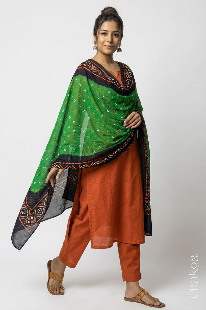 Model wearing Mehendi Green Bandhani Mul Cotton Dupatta in Traditional Design over a rust kurta set.