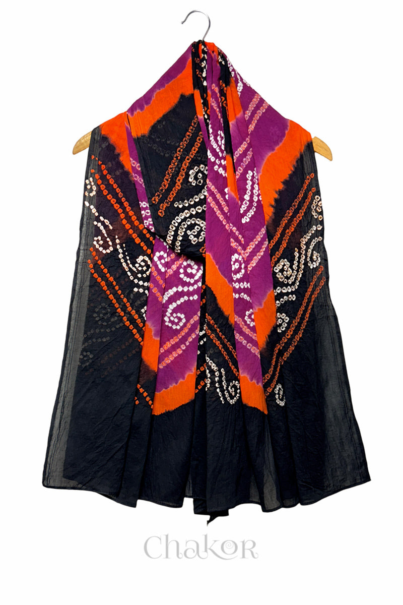 Magenta and black Bandhani mul cotton dupatta draped on hanger showing multicolour tie-dye bands and patterned layout.