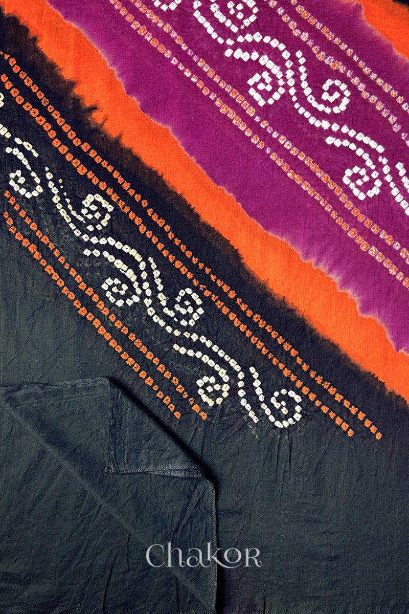 Detail view of black pallu of Bandhani mul cotton dupatta with magenta and orange dyed bands.