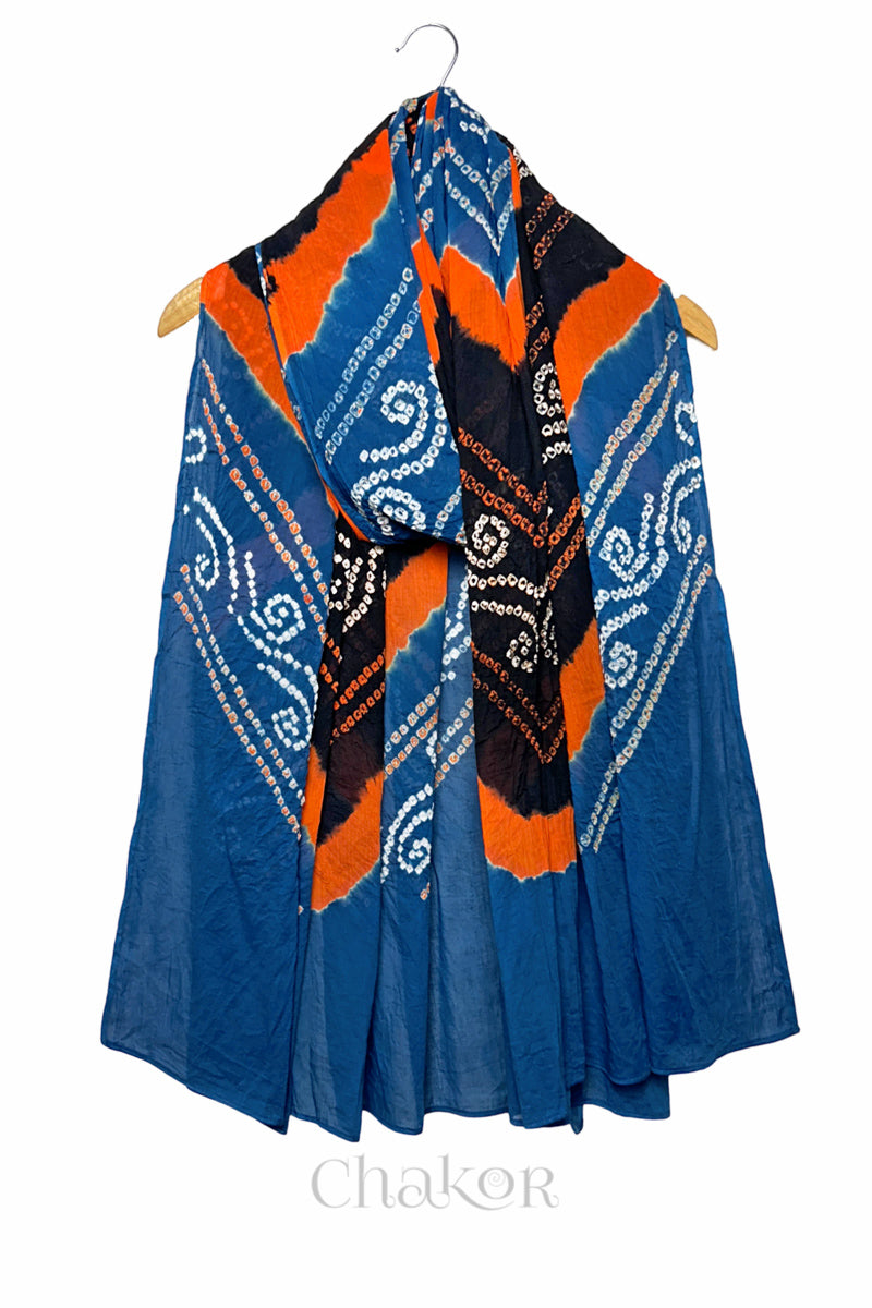 Indigo and black Bandhani mul cotton dupatta draped on hanger showing multicolour tie-dye bands and patterned layout.