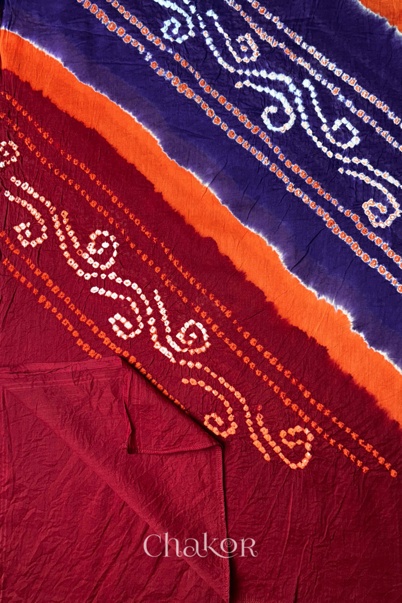 Detail view of red pallu of Bandhani mul cotton dupatta with purple and orange dyed bands.