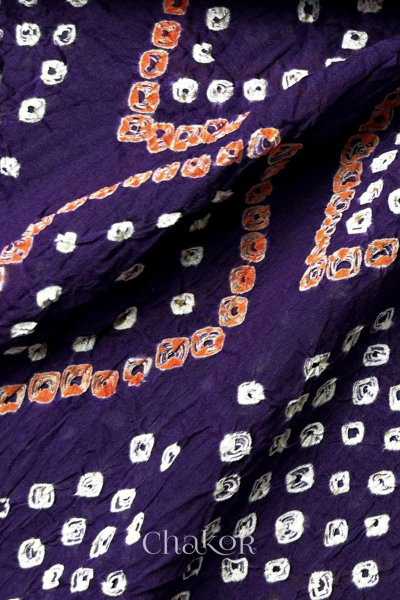 Close-up of Bandhani tie-dye details on Purple Mul Cotton Dupatta with white and yellow dot patterns by Chakor.
