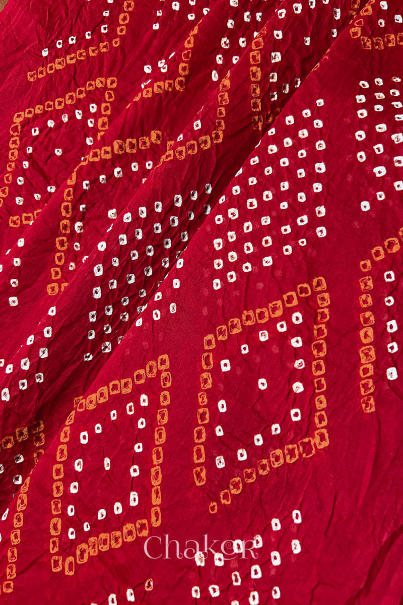 Detailed texture view of Chorkat Bandhani motifs on Tomato Red Mul Cotton Dupatta by Chakor.
