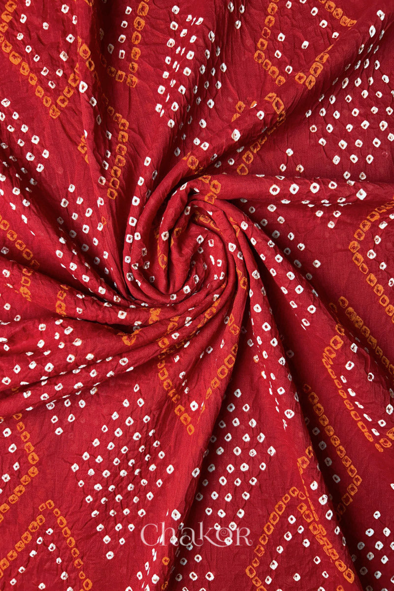 Swirl shot showing Bandhani dot clusters and diamond motifs on Red Mul Cotton Dupatta by Chakor.
