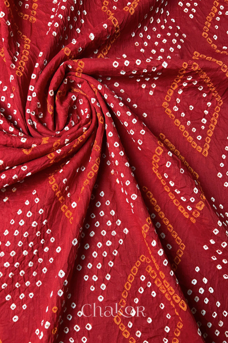 Fabric swirl close-up of Red Bandhani Mul Cotton Dupatta highlighting dense tie-dye work  by Chakor.