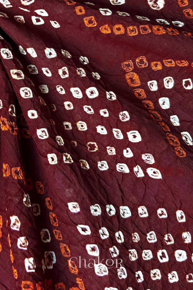 Close-up of Bandhani tie-dye details on Maroon Mul Cotton Dupatta with white and yellow dot patterns by Chakor.