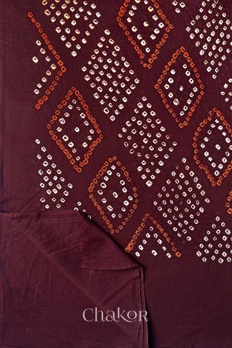 Flatlay of Maroon Bandhani Mul Cotton Dupatta with Chorkat diamond layout and border view  by Chakor.
