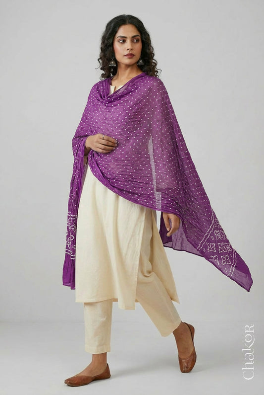 Model wearing violet purple Bandhani mul cotton dupatta with tie-dye dot pattern paired with a white kurta.