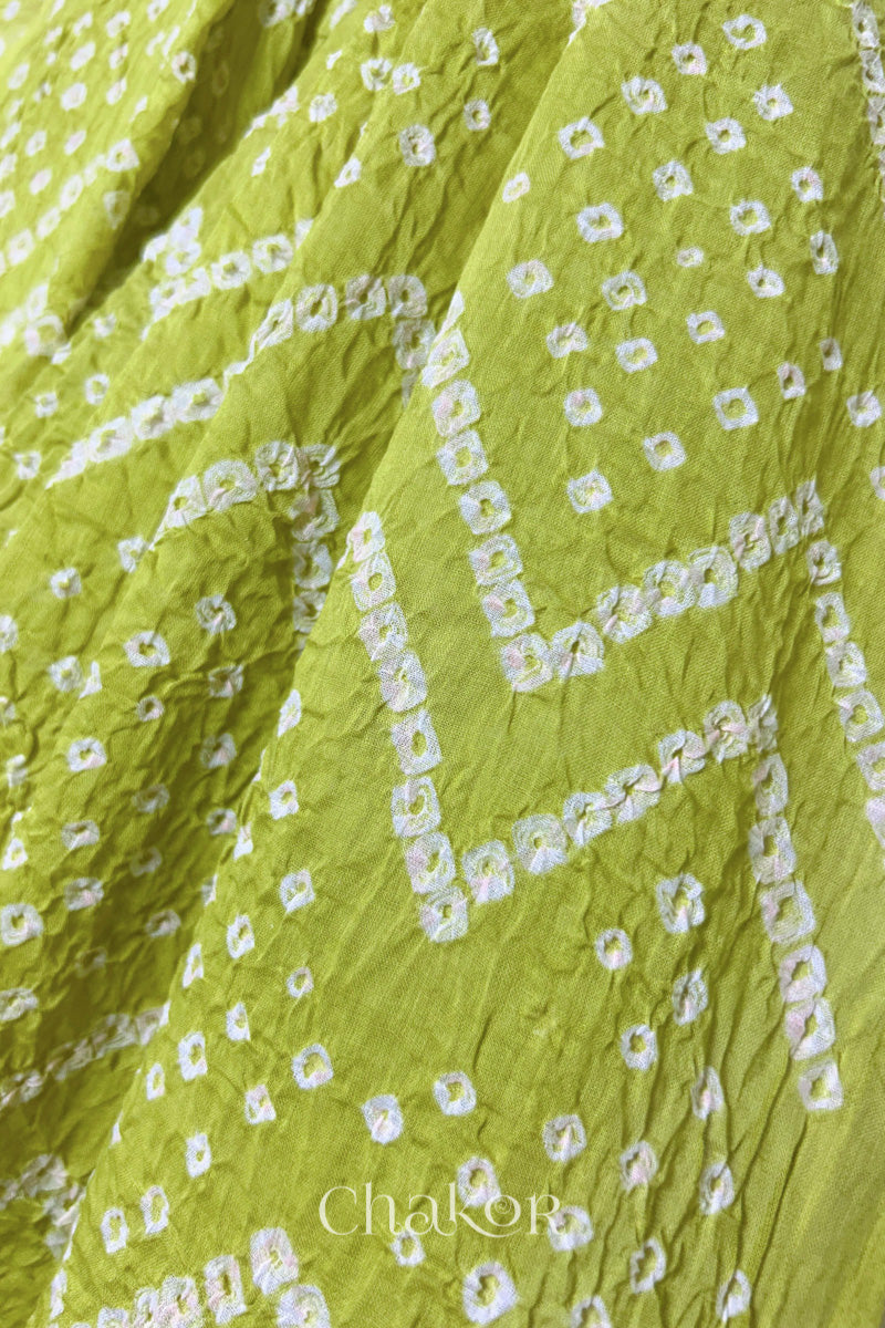 Close up of Traditional hand tied Bandhani pattern on Lime Green mulmul cotton dupatta.
