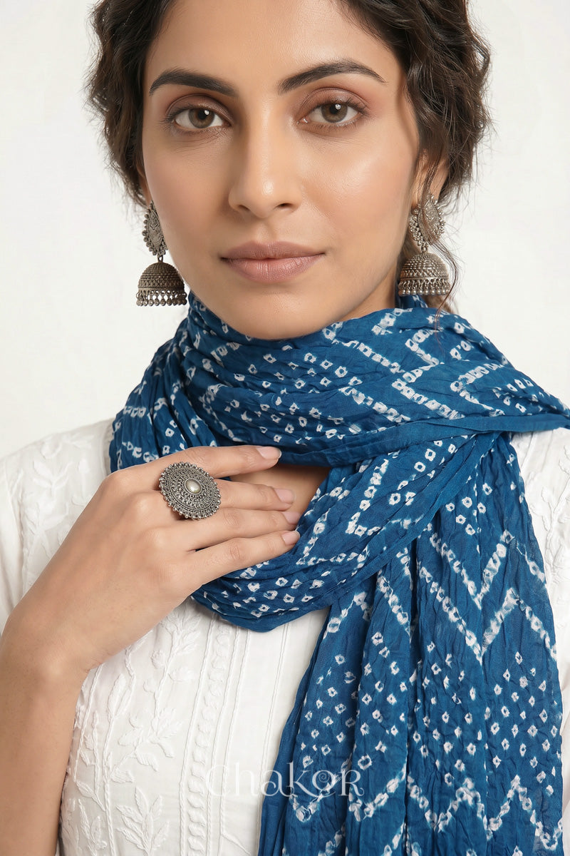 Indigo Blue Kutch Bandhani mulmul dupatta wrapped around woman's neck.
