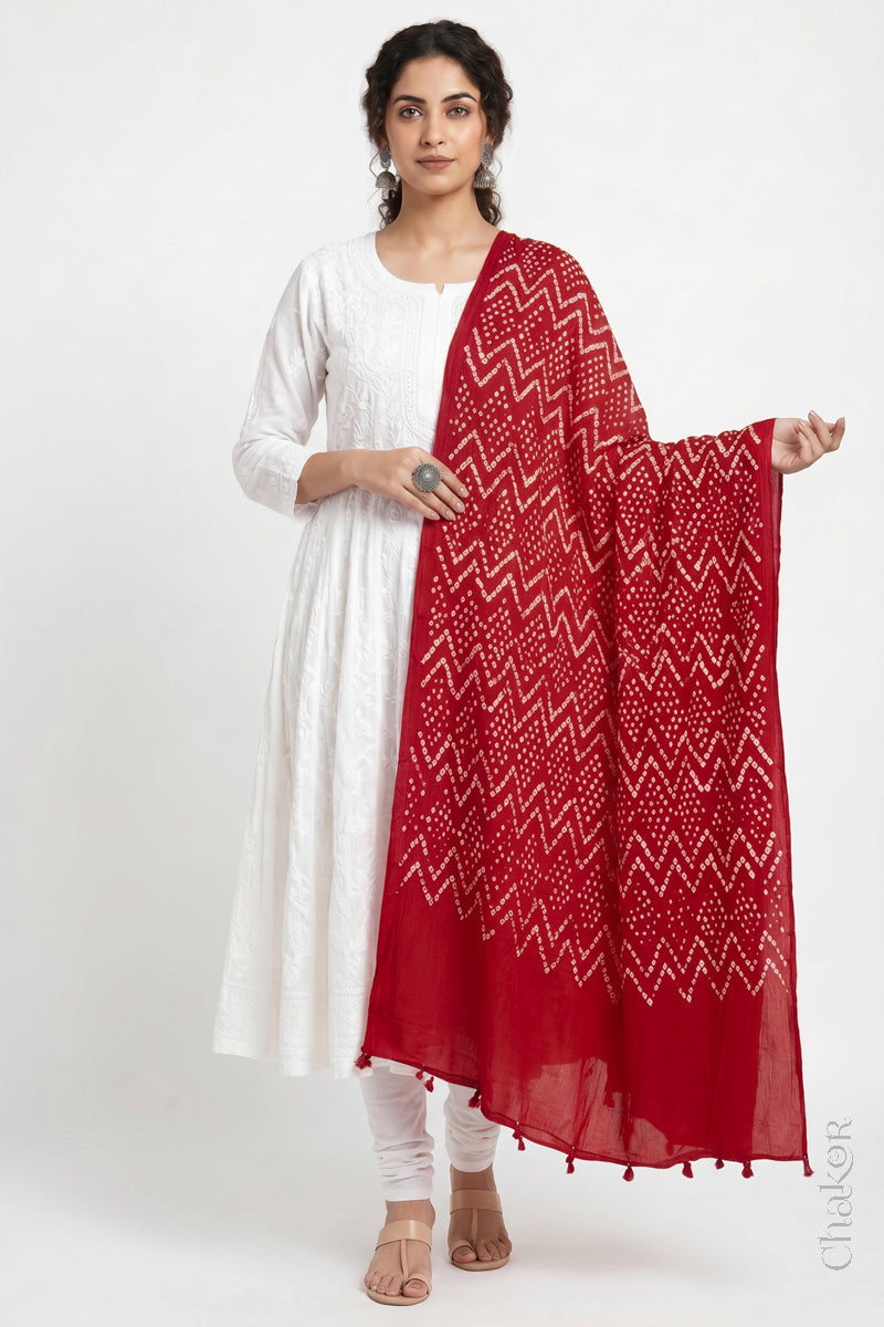 Red Kutch Bandhani dupatta in lightweight mercerised mulmul cotton with flowing drape.
