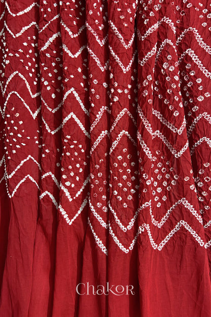 Detailed view of Bandhani tie-dye pattern and fabric fall on Red cotton dupatta.
