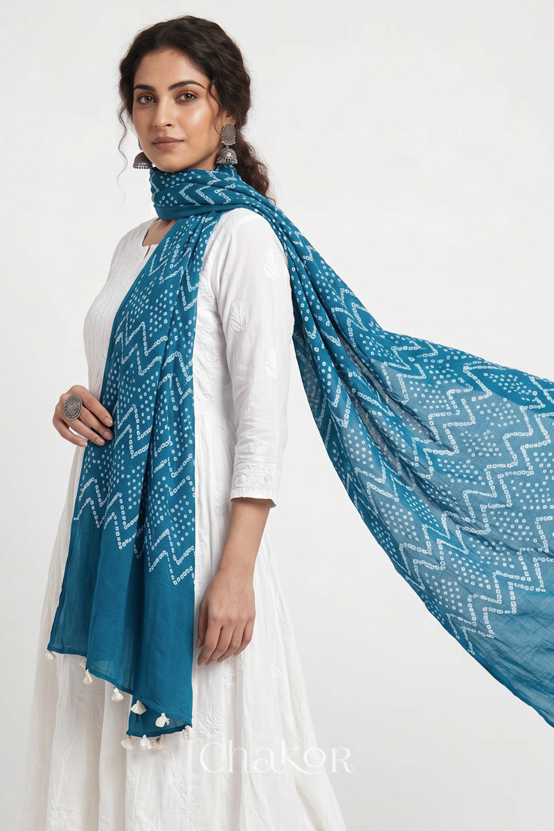 Hand tied Turquoise Blue Kutch Bandhani dupatta in pure mercerised mulmul cotton worn by model.
