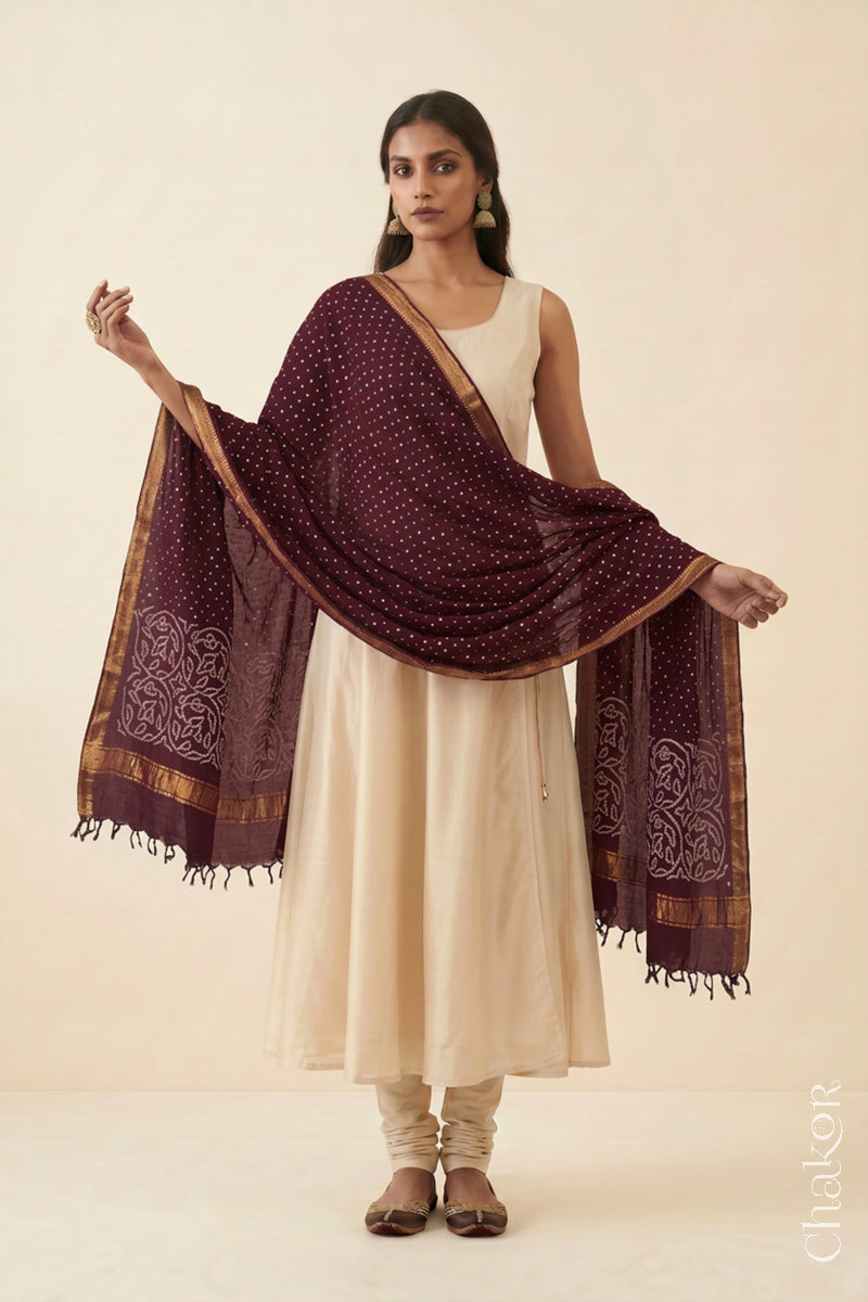 Maroon Bandhani Mangalgiri cotton dupatta worn by a woman, showing the zari border and pallu.
