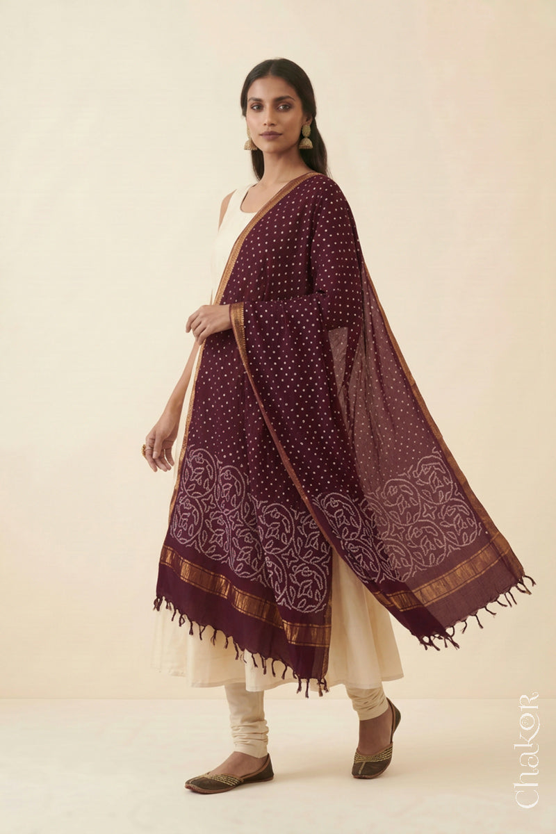 Maroon Bandhani handloom Mangalgiri cotton dupatta worn by a woman, shown in motion.
