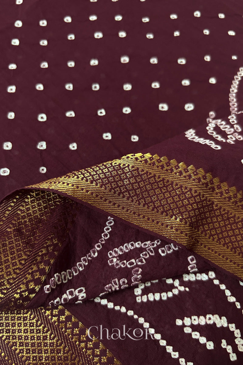 Close-up of the golden zari border on maroon handloom Mangalgiri cotton Bandhani dupatta.
