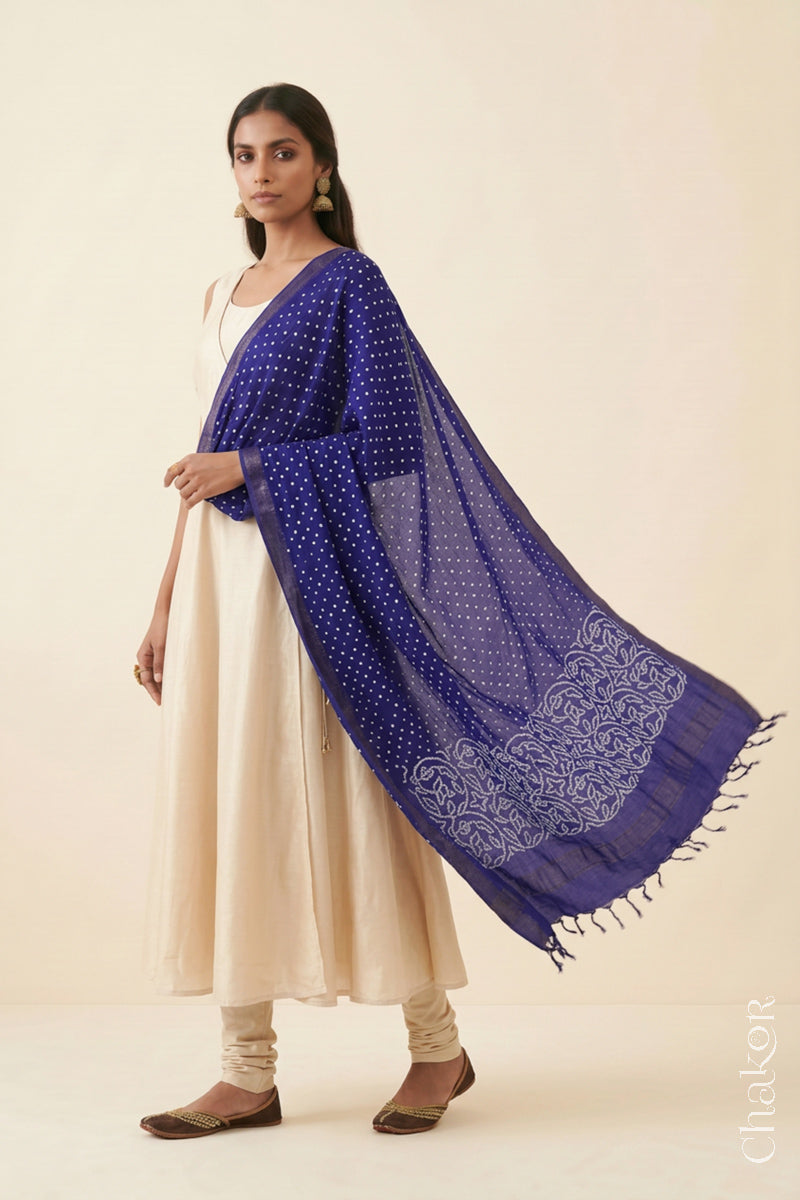 Navy blue Bandhani Mangalgiri cotton dupatta worn by a woman, showing the zari border and pallu.
