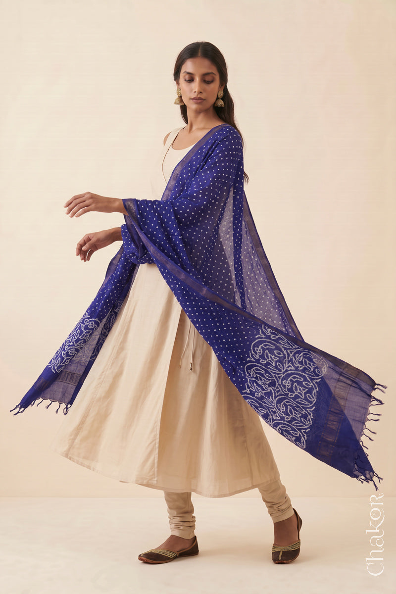 Navy blue Bandhani handloom Mangalgiri cotton dupatta worn by a woman, shown in motion.
