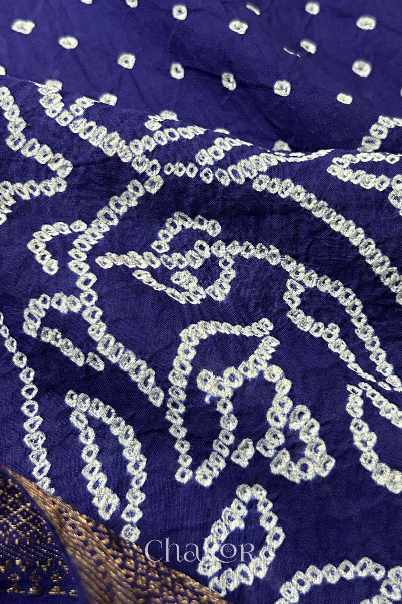 Close-up of white pearl-like dots in the Navy blue Kutch Bandhani tie-dye pattern.

