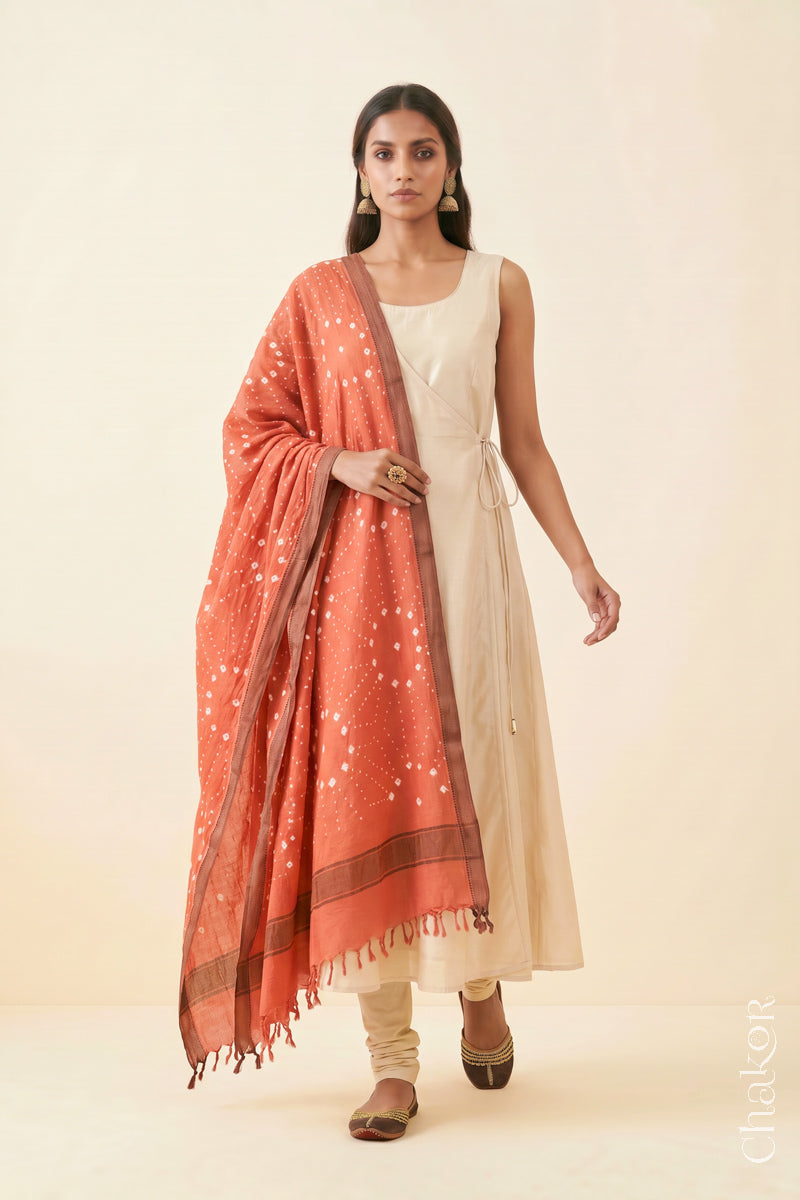 Peach Bandhani handloom Mangalgiri cotton dupatta worn by a woman, shown in motion.
