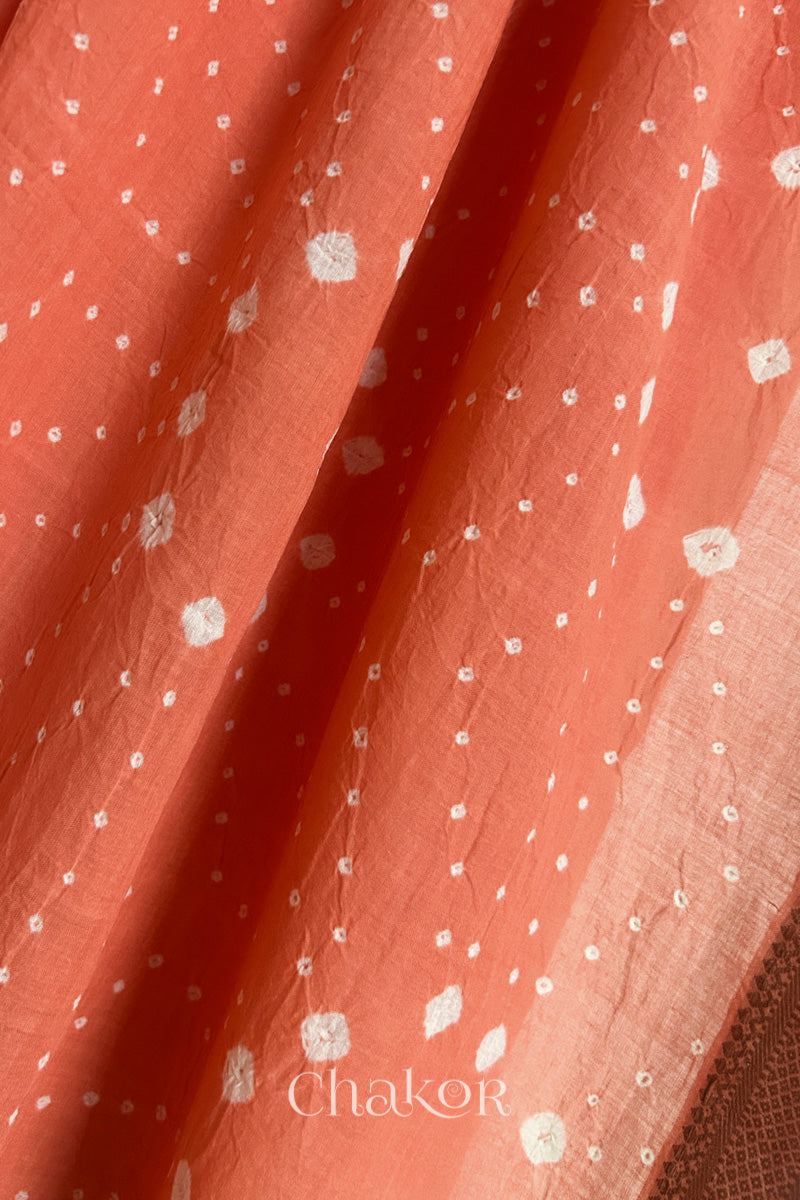 Close-up of Peach Mangalgiri cotton fabric showing its handloom weave and opacity.

