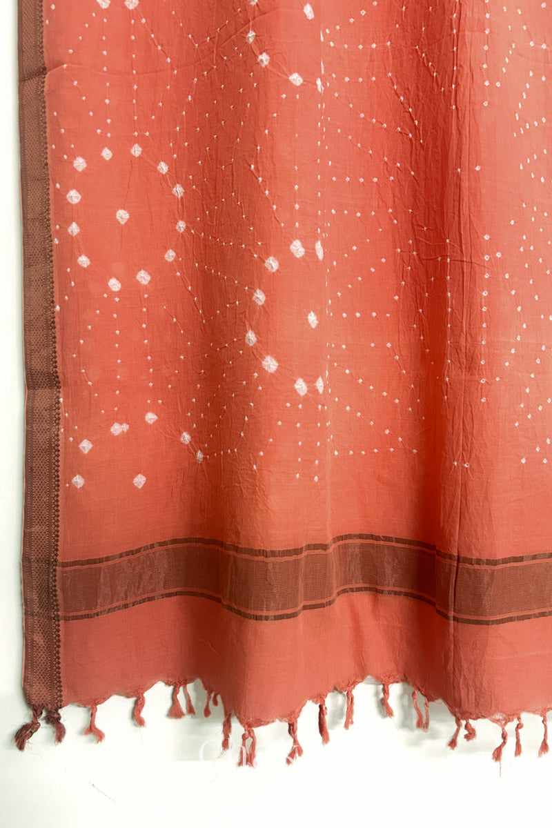 Peach Bandhani Mangalgiri cotton dupatta, showing the draped of patterned pallu, golden zari detailing and tassels.
