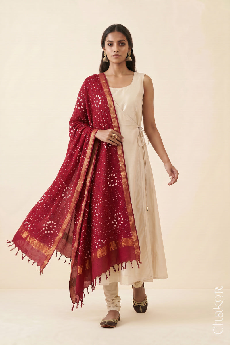 Red Bandhani Mangalgiri cotton dupatta worn by a woman, showing the zari border and pallu.

